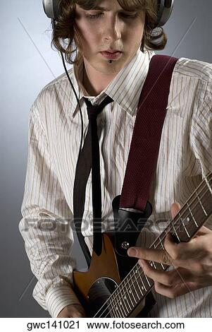 Close-up of a guitarist playing a guitar View Large Photo Image Stock Image - Close-up of a guitarist playing a guitar. Fotosearch