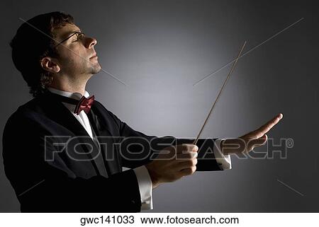Close-up of a music conductor performing View Large Photo Image Stock Image - Close-up of a music conductor performing. Fotosearch