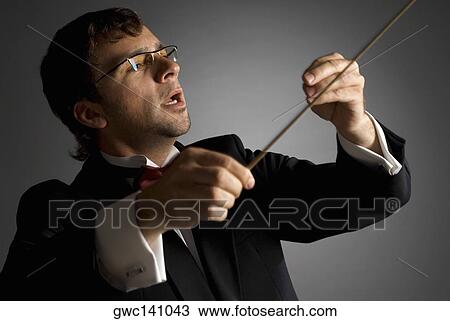 Close-up of a music conductor performing View Large Photo Image Stock Image - Close-up of a music conductor performing. Fotosearch