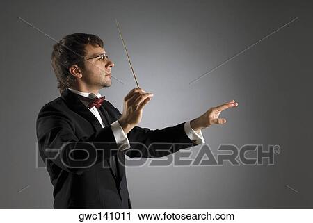 Stock Image - Close-up of a musician holding a conductor's baton. Fotosearch