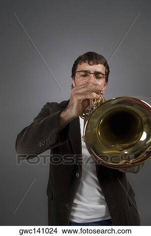 Close-up of a musician playing a trumpet View Large Photo Image Picture - Close-up of a musician playing a trumpet. Fotosearch