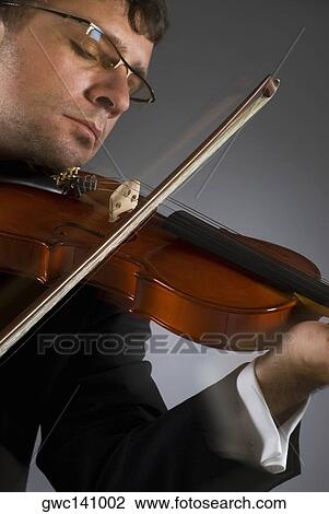 Close-up of a musician playing a violin View Large Photo Image Stock Image - Close-up of a musician playing a violin. Fotosearch