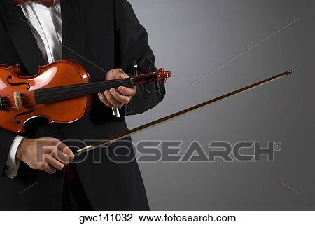 Stock Image - Close-up of a musician playing a violin. Fotosearch