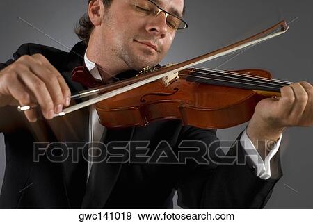 Stock Photo - Close-up of a musician playing a violin. Fotosearch