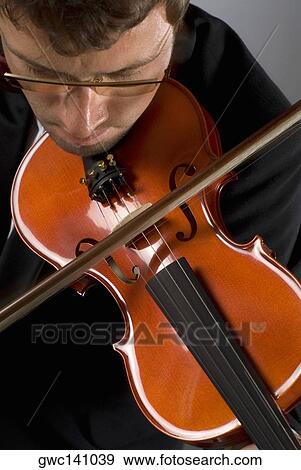 Stock Photo - Close-up of a musician playing a violin. Fotosearch
