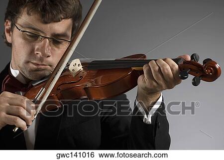 Close-up of a musician playing a violin View Large Photo Image Stock Photograph - Close-up of a musician playing a violin. Fotosearch