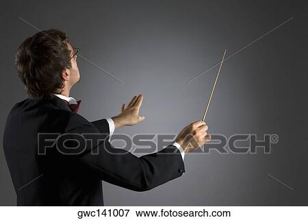 Stock Photo - Side profile of a music conductor performing. Fotosearch