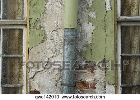 Stock Image - Close-up of a pipe mounted on a wall. Fotosearch