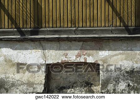 Stock Image - Close-up of a railing on a weathered wall. Fotosearch