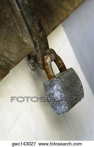 Close-up of a padlock on a wooden door View Large Photo Image Stock Photo - Close-up of a padlock on a wooden door. Fotosearch