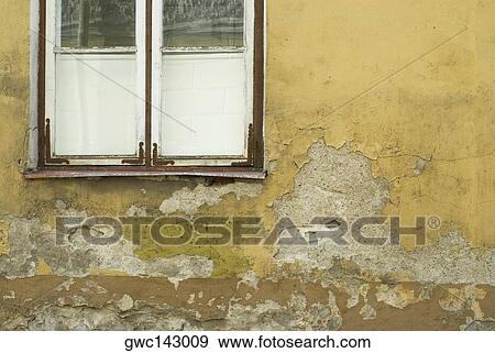 Close-up of an old window on a weathered wall View Large Photo Image Stock Photo - Close-up of an old window on a weathered wall. Fotosearch