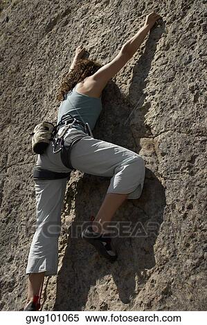 Female rock climber scaling a rock face View Large Photo Image Stock Photography - Female rock climber scaling a rock face. Fotosearch