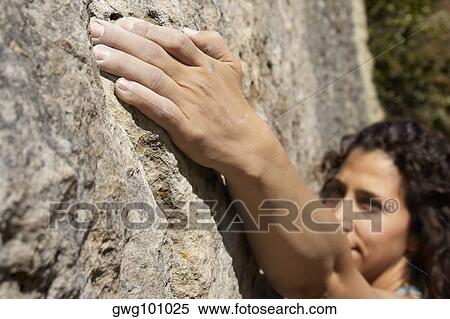 High angle view of a female rock climber scaling a rock face View Large Photo Image Stock Photography - High angle view of a female rock climber scaling a rock face. Fotosearch
