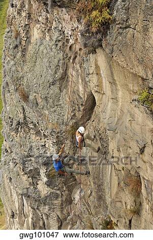 High angle view of a male and a female rock climber scaling a rock face View Large Photo Image Stock Photo - High angle view of a male and a female rock climber scaling a rock face. Fotosearch