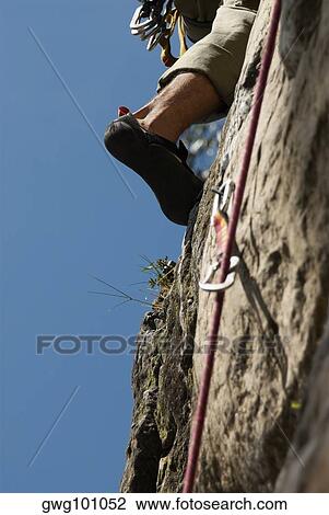 Low angle view of a climbers' leg scaling a rock face View Large Photo Image Stock Image - Low angle view of a climbers' leg scaling a rock face. Fotosearch