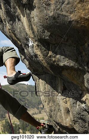 Low section view of a rock climber on a rock View Large Photo Image Stock Image - Low section view of a rock climber on a rock. Fotosearch