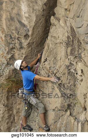 Male rock climber scaling a rock face View Large Photo Image Stock Photography - Male rock climber scaling a rock face. Fotosearch
