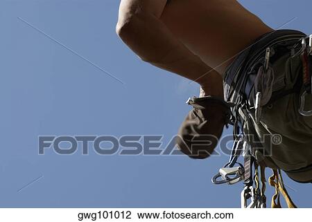 Mid section view of a climber hanging in air View Large Photo Image Stock Image - Mid section view of a climber hanging in air. Fotosearch