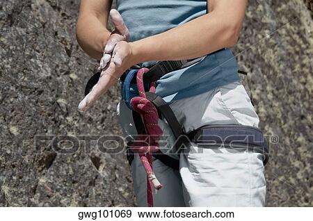Mid section view of a female climber rubbing chalk on his hands View Large Photo Image Stock Photo - Mid section view of a female climber rubbing chalk on his hands. Fotosearch