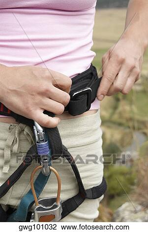Mid section view of a female rock climber adjusting harness View Large Photo Image Stock Image - Mid section view of a female rock climber adjusting harness. Fotosearch