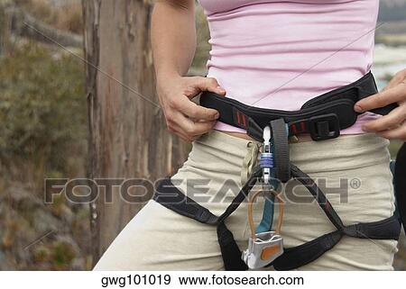 Mid section view of a female rock climber wearing harness View Large Photo Image Stock Photo - Mid section view of a female rock climber wearing harness. Fotosearch