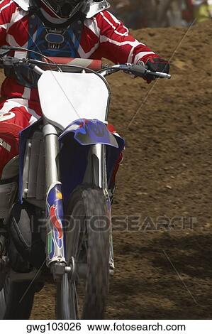 Close-up of a motocross rider riding a motorcycle View Large Photo Image Stock Photograph - Close-up of a motocross rider riding a motorcycle. Fotosearch