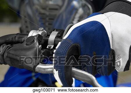 Close-up of a motocross rider's hand on the handlebar of a motorcycle View Large Photo Image Stock Image - Close-up of a motocross rider's hand on the handlebar of a motorcycle. Fotosearch