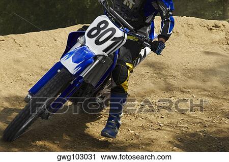 Low section view of a motocross rider riding a motorcycle View Large Photo Image Stock Image - Low section view of a motocross rider riding a motorcycle. Fotosearch