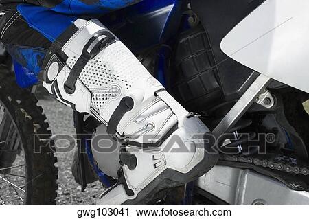 Stock Image - Low section view of a motocross rider. Fotosearch