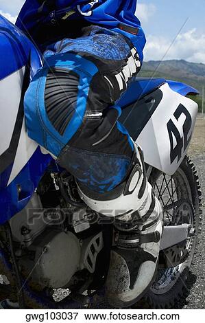 Low section view of a motocross rider riding a motorcycle View Large Photo Image Stock Photo - Low section view of a motocross rider riding a motorcycle. Fotosearch
