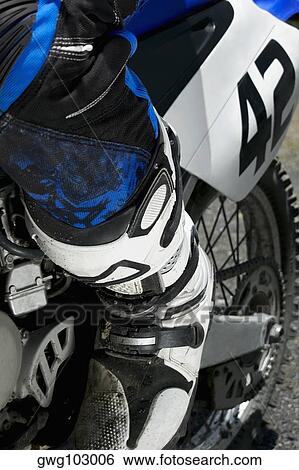 Low section view of a motocross rider riding a motorcycle View Large Photo Image Stock Photograph - Low section view of a motocross rider riding a motorcycle. Fotosearch
