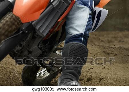 Low section view of a motocross rider riding a motorcycle View Large Photo Image Stock Photography - Low section view of a motocross rider riding a motorcycle. Fotosearch