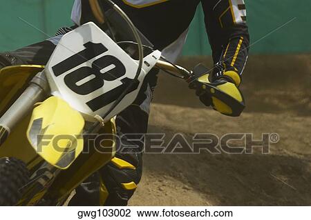 Mid section view of a motocross rider riding a motorcycle View Large Photo Image Stock Image - Mid section view of a motocross rider riding a motorcycle. Fotosearch