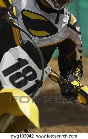 Mid section view of a motocross rider riding a motorcycle View Large Photo Image Stock Image - Mid section view of a motocross rider riding a motorcycle. Fotosearch