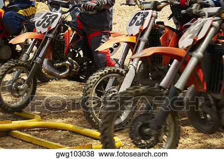 Mid section view of motocross riders on their motorcycles View Large Photo Image Stock Photo - Mid section view of motocross riders on their motorcycles. Fotosearch