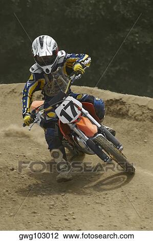 Motocross rider leaning into a turn View Large Photo Image Stock Image - Motocross rider leaning into a turn. Fotosearch