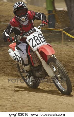 Motocross rider riding a motorcycle and leaning into a turn View Large Photo Image Stock Photograph - Motocross rider riding a motorcycle and leaning into a turn. Fotosearch