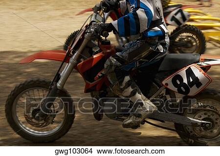 Motocross rider riding a motorcycle View Large Photo Image Picture - Motocross rider riding a motorcycle. Fotosearch