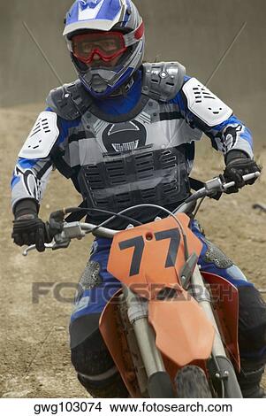Motocross rider riding a motorcycle View Large Photo Image Picture - Motocross rider riding a motorcycle. Fotosearch