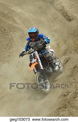 Motocross rider riding a motorcycle View Large Photo Image Stock Image - Motocross rider riding a motorcycle. Fotosearch