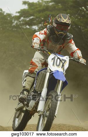 Stock Photo - Motocross rider riding a motorcycle. Fotosearch