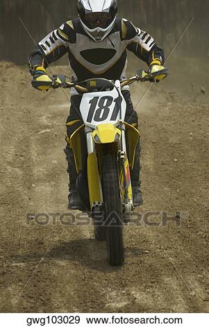 Motocross rider riding a motorcycle View Large Photo Image Stock Photo - Motocross rider riding a motorcycle. Fotosearch