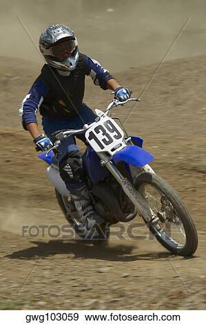 Motocross rider riding a motorcycle View Large Photo Image Stock Photo - Motocross rider riding a motorcycle. Fotosearch