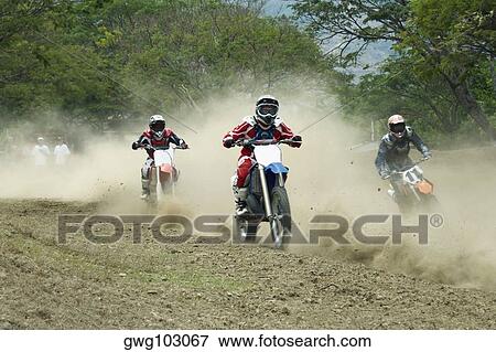 Motocross riders riding motorcycles View Large Photo Image Stock Photo - Motocross riders riding motorcycles. Fotosearch