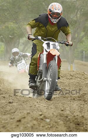 Motocross riders riding motorcycles View Large Photo Image Stock Photography - Motocross riders riding motorcycles. Fotosearch