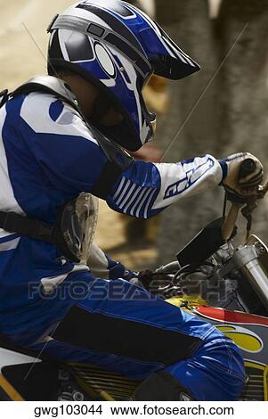 Side profile of a motocross rider riding a motorcycle View Large Photo Image Picture - Side profile of a motocross rider riding a motorcycle. Fotosearch