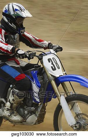 Side profile of a motocross rider riding a motorcycle View Large Photo Image Stock Image - Side profile of a motocross rider riding a motorcycle. Fotosearch