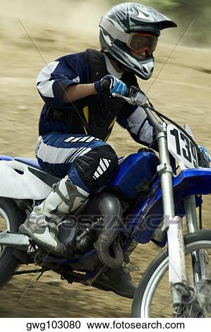 Side profile of a motocross rider riding a motorcycle View Large Photo Image Stock Image - Side profile of a motocross rider riding a motorcycle. Fotosearch