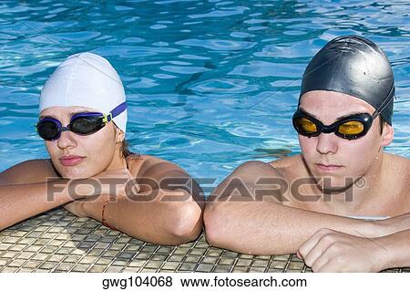 Close-up of a young couple at the edge of a swimming pool View Large Photo Image Stock Photo - Close-up of a young couple at the edge of a swimming pool. Fotosearch
