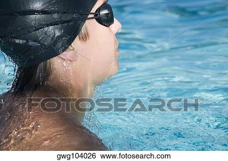 Stock Photograph - Close-up of a young man swimming in a swimming pool. Fotosearch
